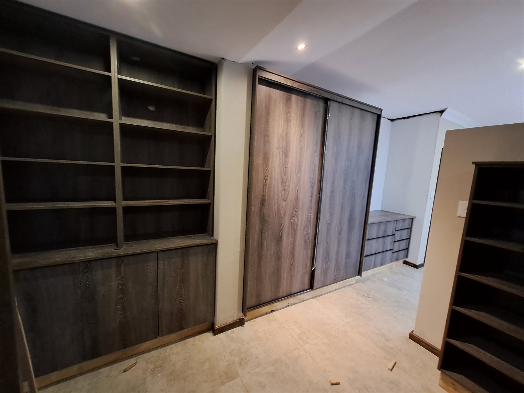 Dark wood walk-in wardrobe installation