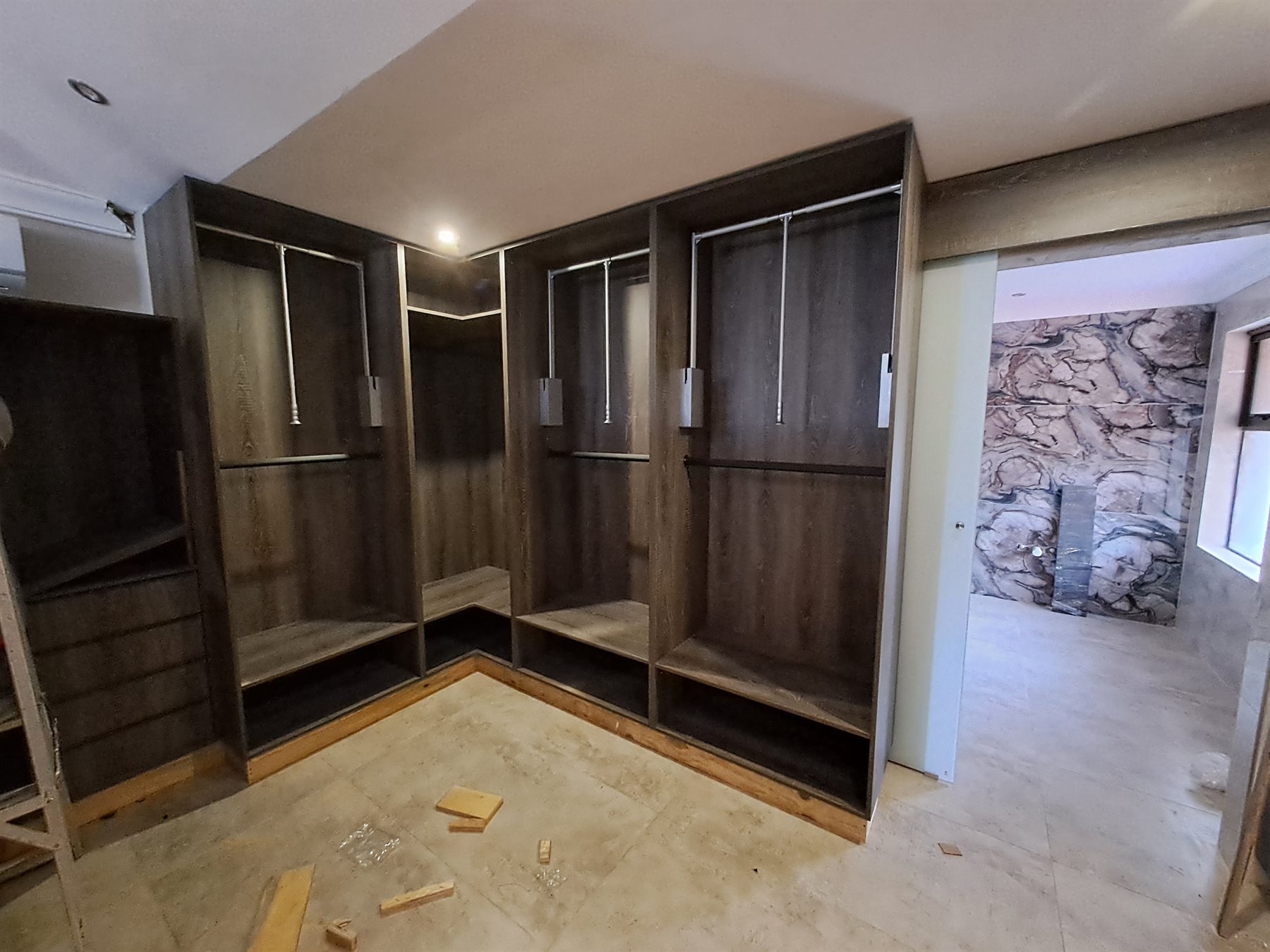 Dark wood walk-in wardrobe installation