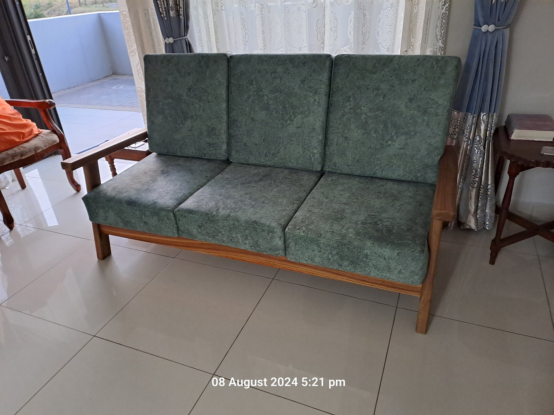 Refurbished wooden sofa with green upholstery