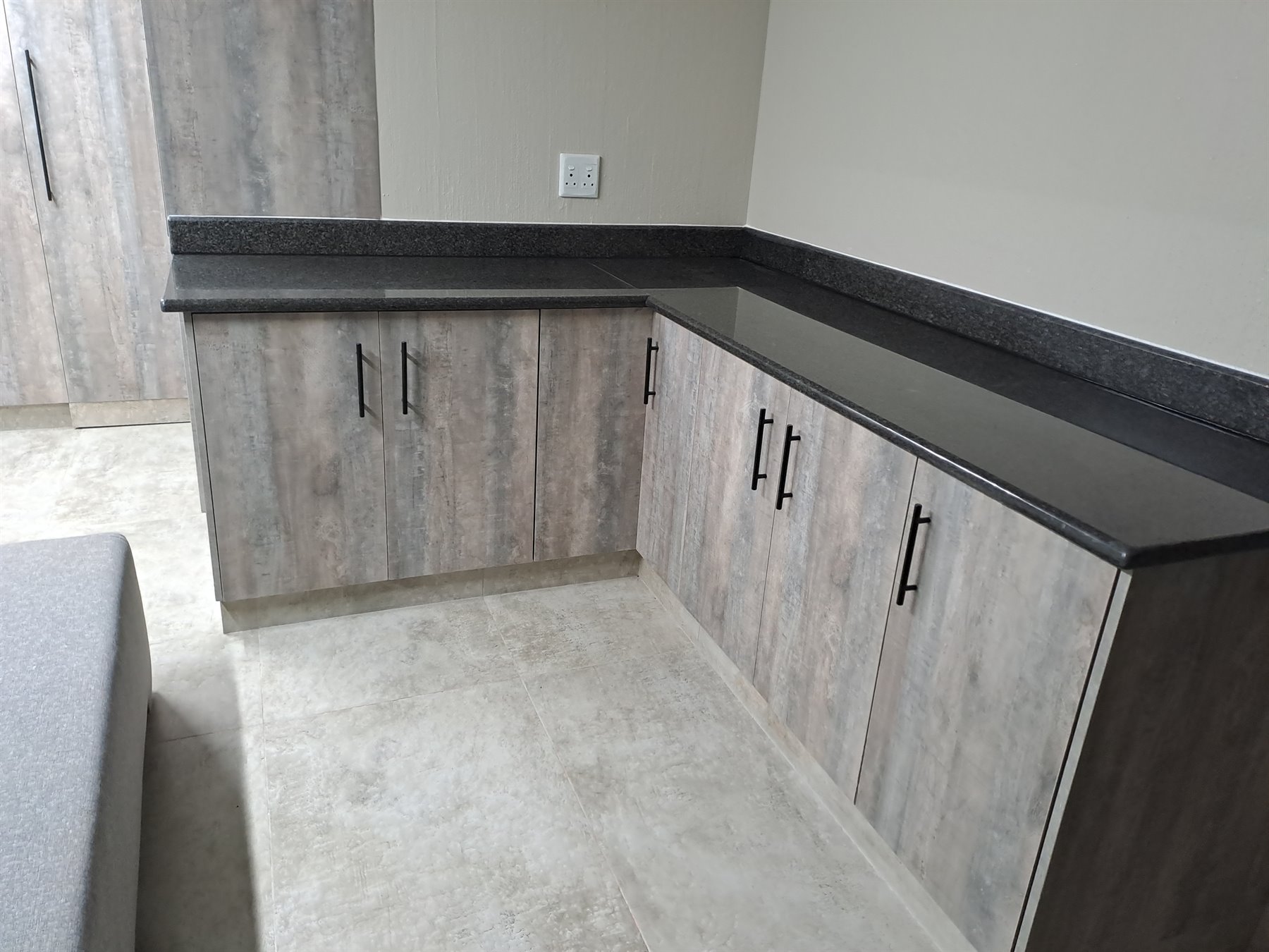 Melamine kitchen cupboards with black countertop