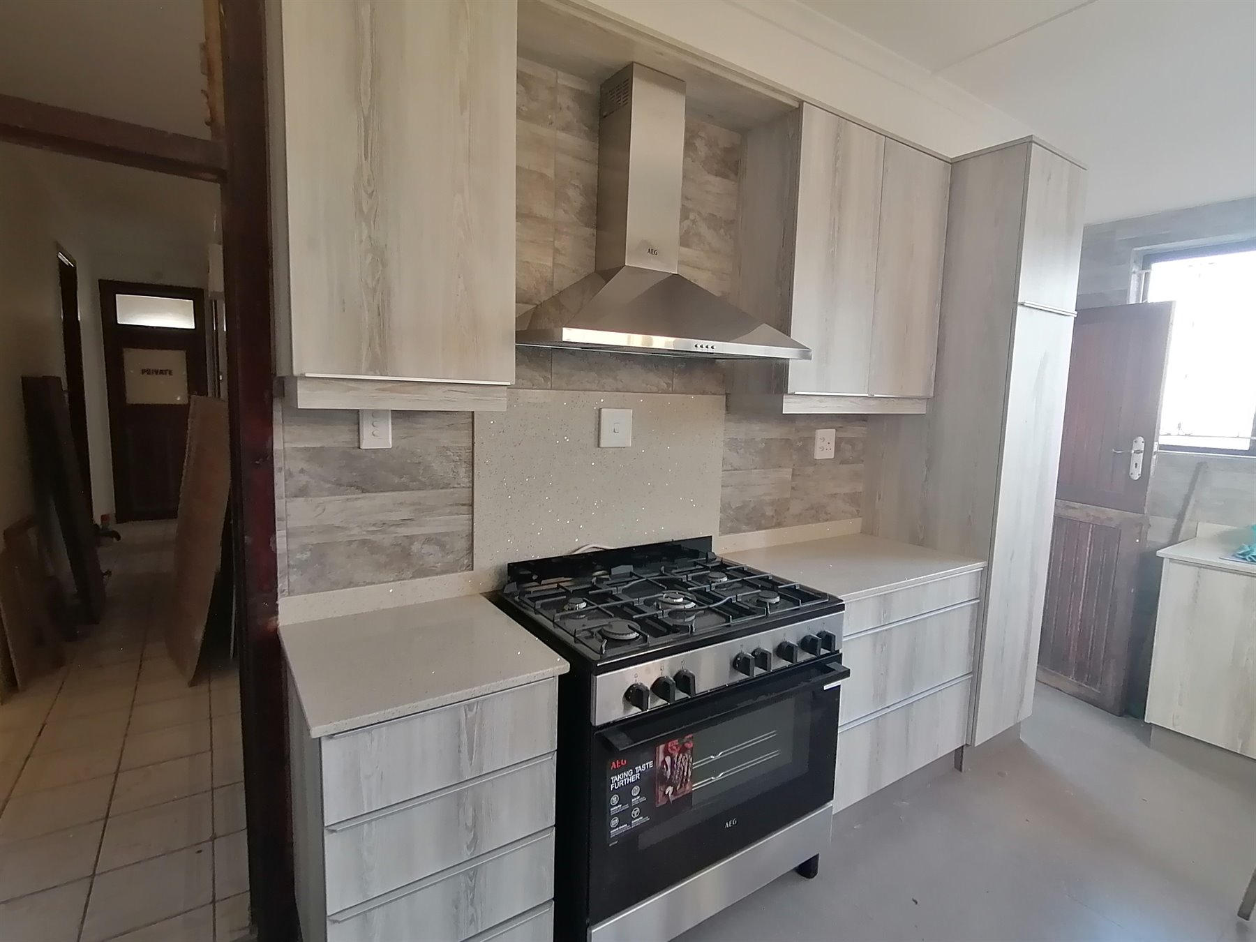 Melamine kitchen cabinetry and stove area