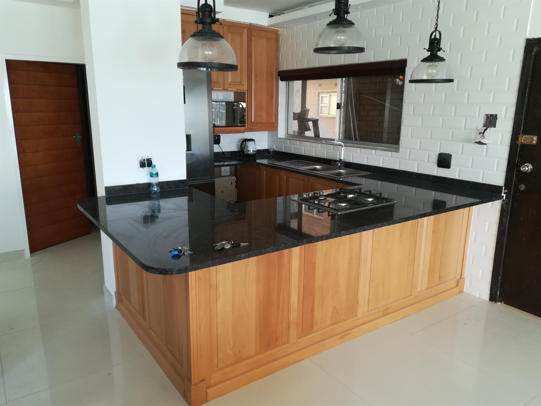 Solid wood kitchen island with black countertop