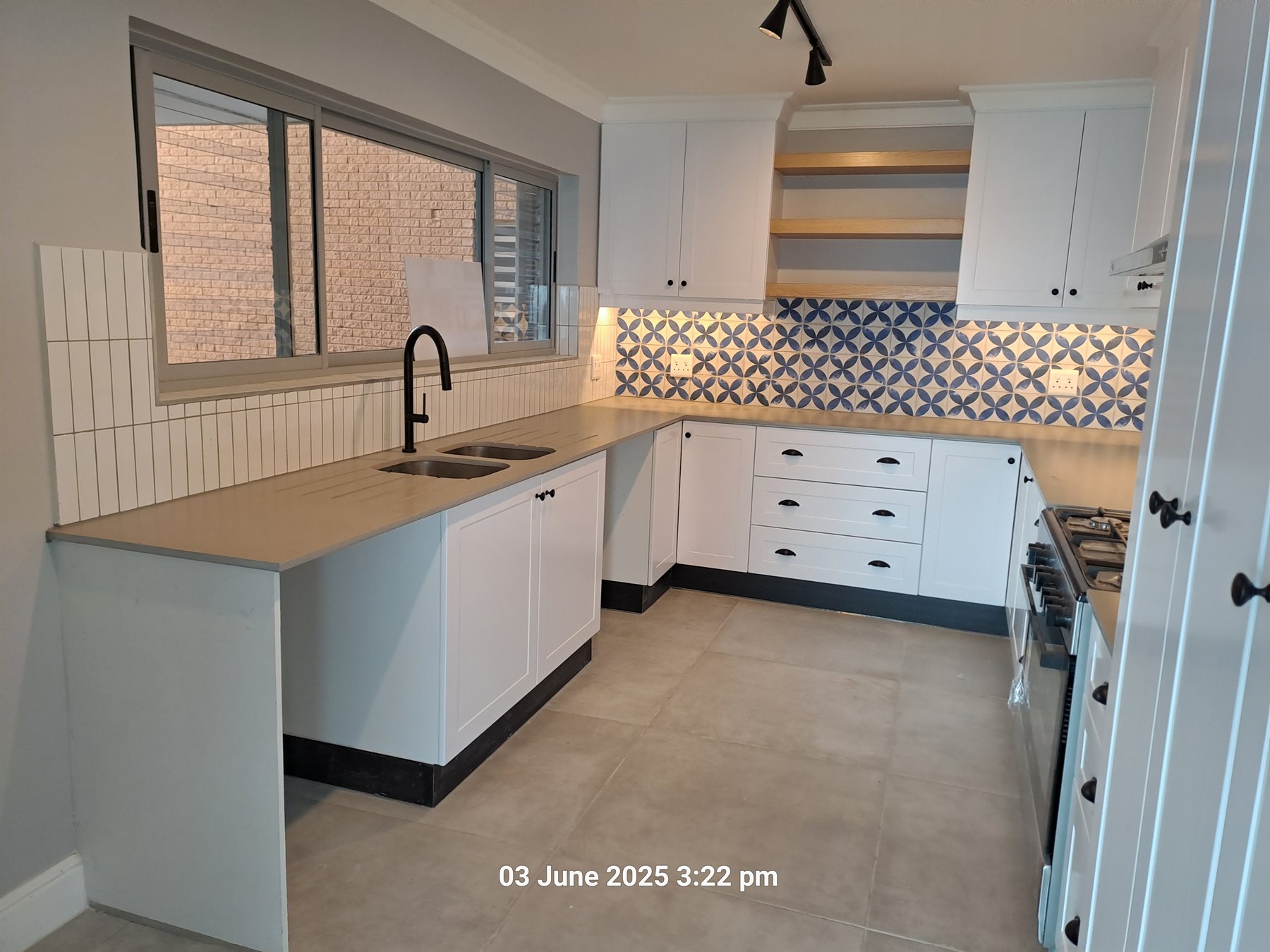 White kitchen cupboards with patterned splashback