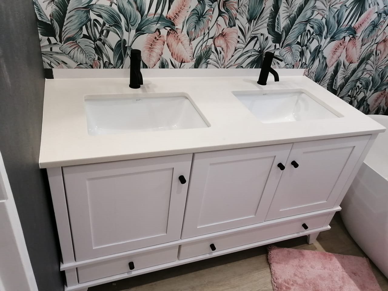 White double bathroom vanity with tropical wallpaper