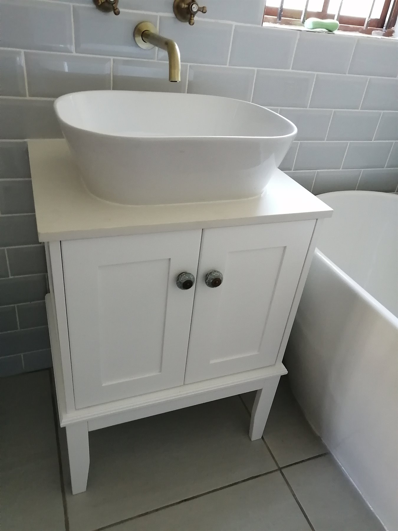 White bathroom vanity with vessel basin