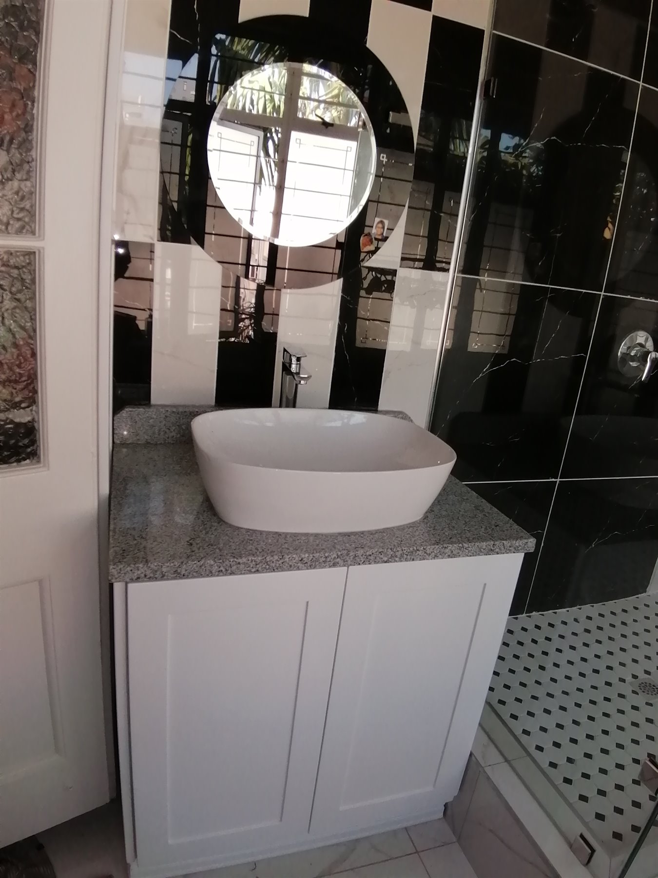 Bathroom vanity with round mirror