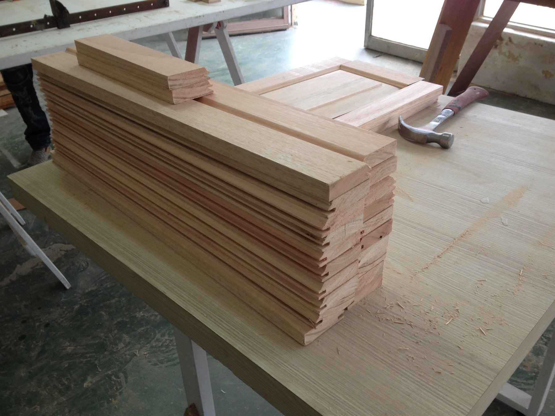 Solid raised panel doors stacked for assembly