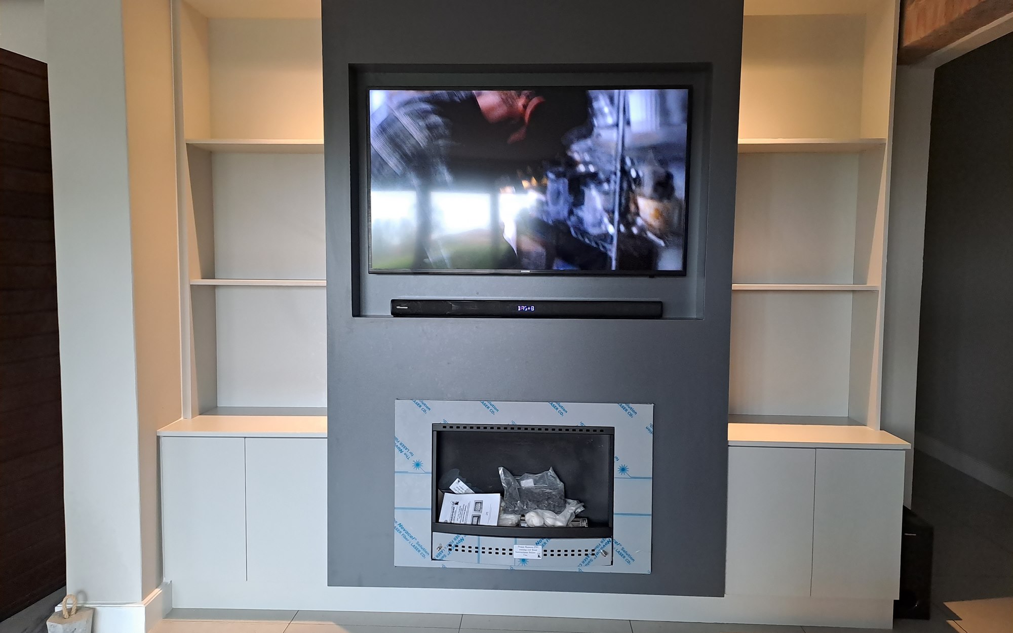 Custom living room TV and fireplace unit built by 2G Custom Furniture